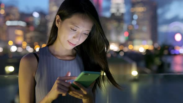 Woman use of mobile phone at night