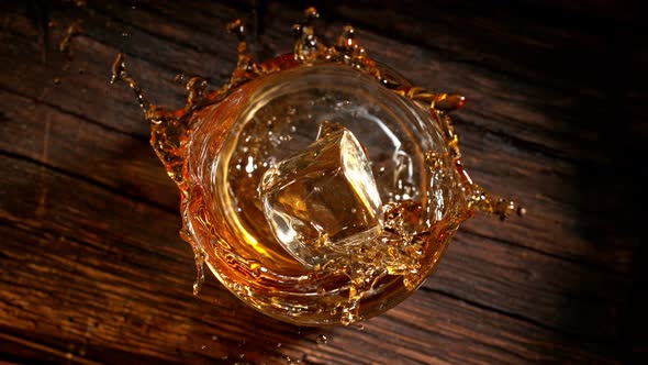 Super Slow Motion Shot of Ice Cube Falling Into Whiskey at 1000Fps