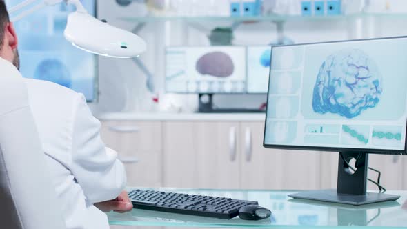 Researcher in Medicine Field Typing in Computer Keyboard, Looking at X Ray Scan