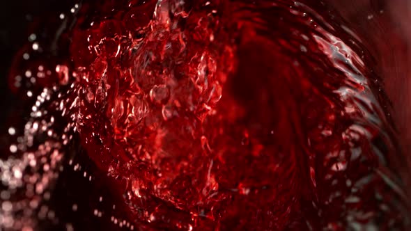 Super Slow Motion Abstract Shot of Red Wine Pouring in Glass Bottle at 1000 Fps.