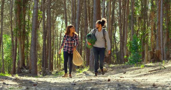 Happy young couple having fun in the forest 4k