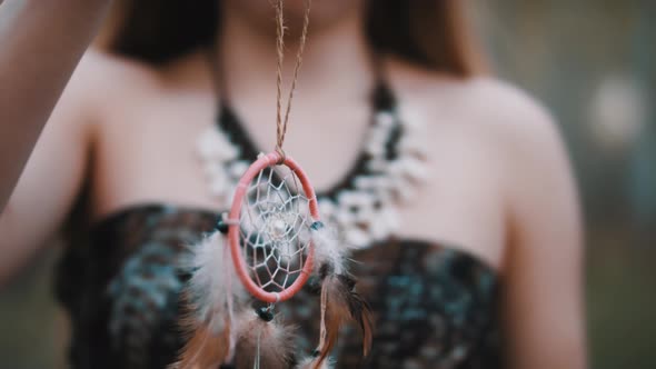 Young Witch Holding Dreamcatcher in the Forest. Close Up. Spirituality and Connection with the