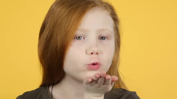 Close-up Red Hair Girl Blows Air Kiss To Someone. Slow Motion