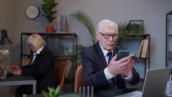 Senior Businessman Grandfather with Mobile Phone Texing Message Working Watching Video Communicating