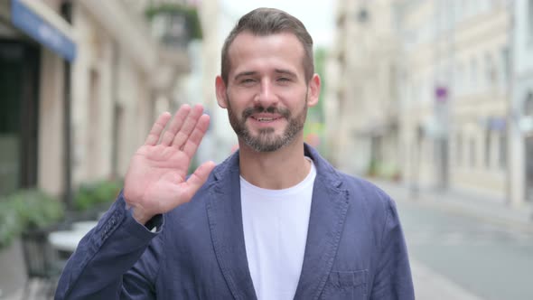 Outdoor Portrait of Man Waving Welcoming