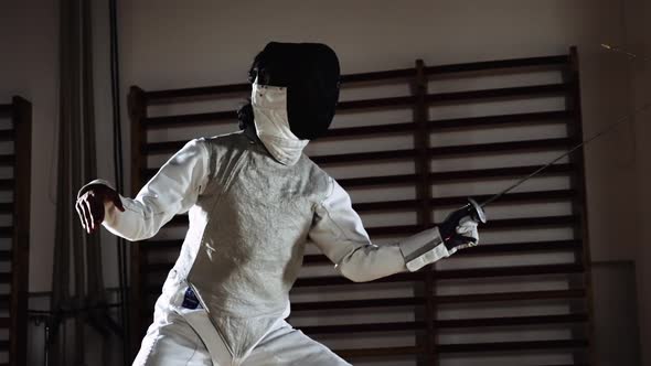 Men In Fencing Masks Thrusting With Foils In Duel