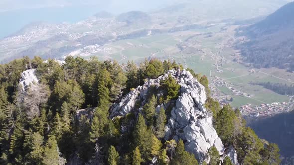 camera pans over a mountain peak and aims down towards the small swiss mountain village "Wimmis", st