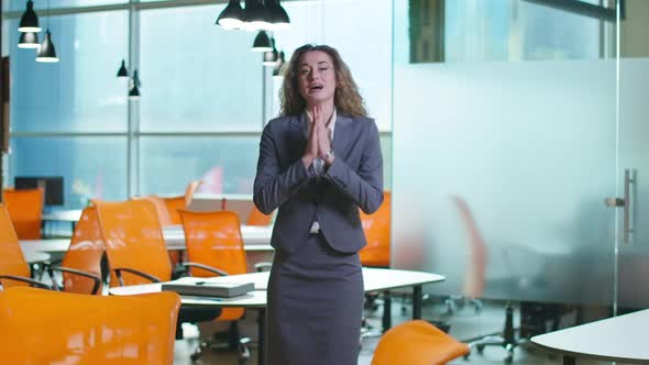 Elegant Confident Intelligent Woman Talking Looking at Camera Standing in Office Indoors