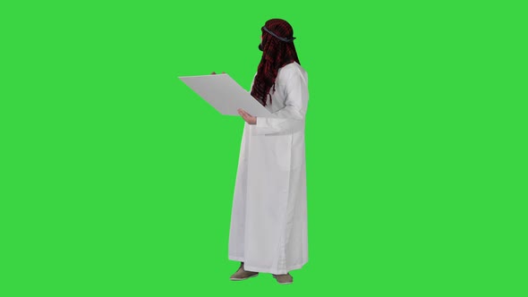 Beautiful Emirate Sheikh Businessman Studying Project of Future Construction on a Green Screen