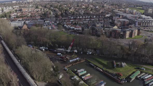 Wide rotating drone shot of house narrow boat marina and repair near London underground