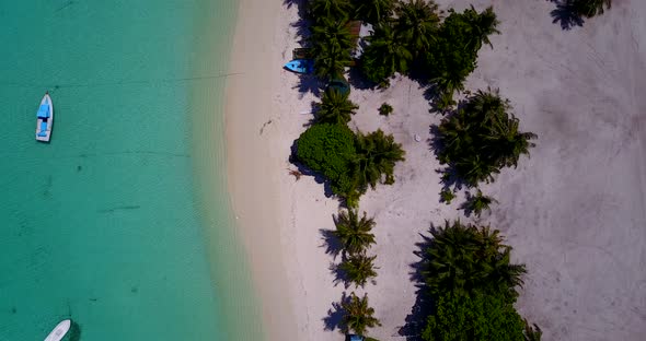 Wide overhead island view of a white sandy paradise beach and aqua turquoise water background in vib