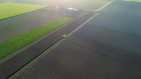 Aerial view of agricultural land during scenic sunset, Netherlands.