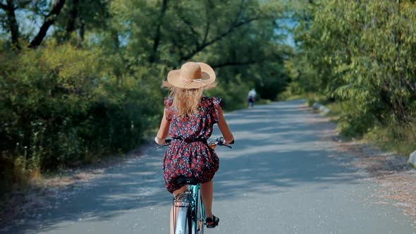 Girl Cyclist On Vacation. Bicycling On Holidays. Girl Having Fun. Woman Cyclist Riding Road Bike.