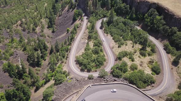 Aerial top down view of car driving on a scenic horseshoe road at Rowena Crest viewpoint in Oregon