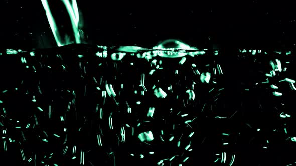 Water is poured on a black background.