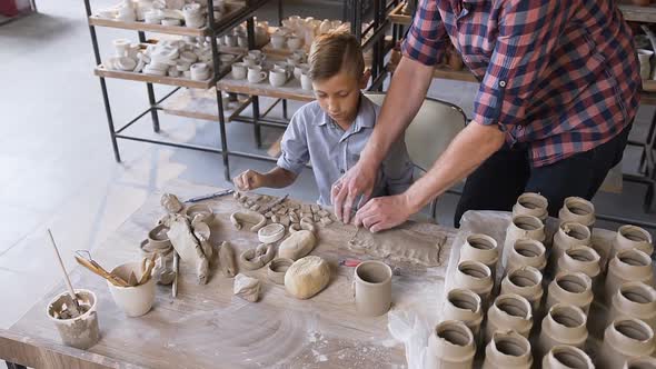 Caucasian Caring Father Helping Little Son Making Ceramic Vase