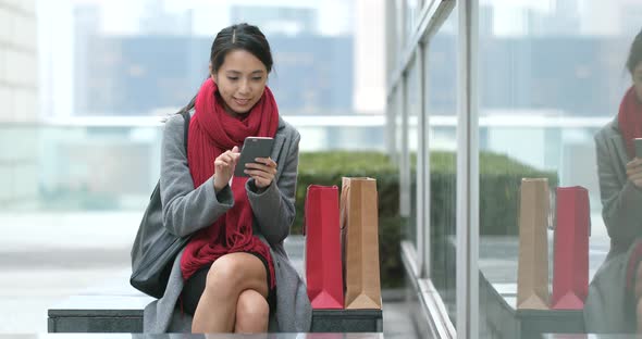 Shopping woman use of mobile phone after shopping