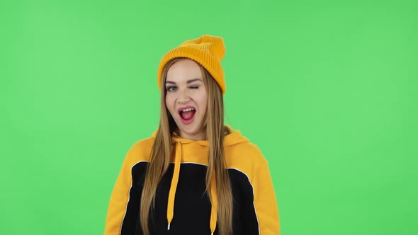 Portrait of Modern Girl in Yellow Hat Is Making Sign Ok. Green Screen
