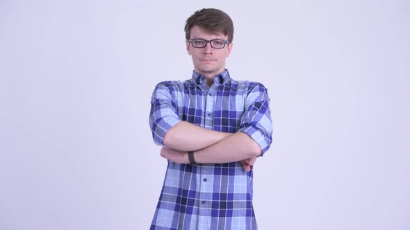 Happy Young Handsome Hipster Man Smiling with Arms Crossed