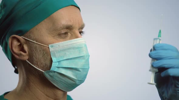 Male Therapist in Face Mask Making Injection With Syringe, Medical Treatment