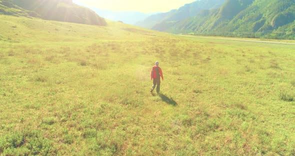 Flight Over Backpack Hiking Tourist Walking Across Green Mountain Field