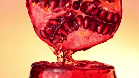 Super Slow Motion From the Pomegranate Pours Juice Into the Glass