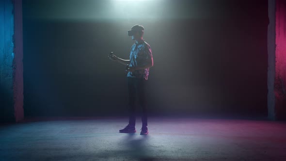 Man In VR Headset Holding Up Controllers