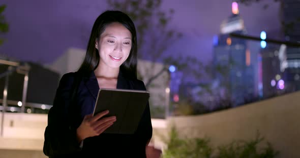 Asian Businesswoman use of tablet computer at night