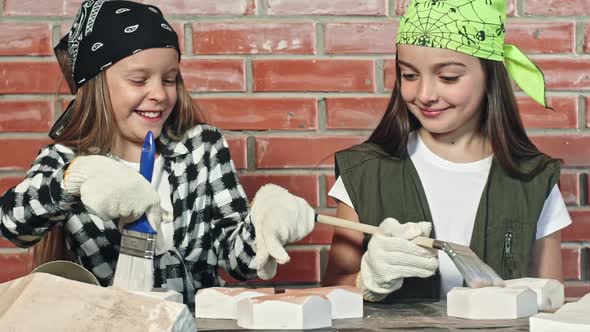 Little Girls Painting Tiles at Table