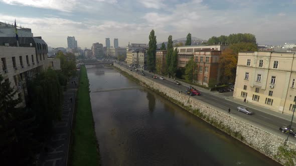 Aerial view of cars driving along Miljacka River 