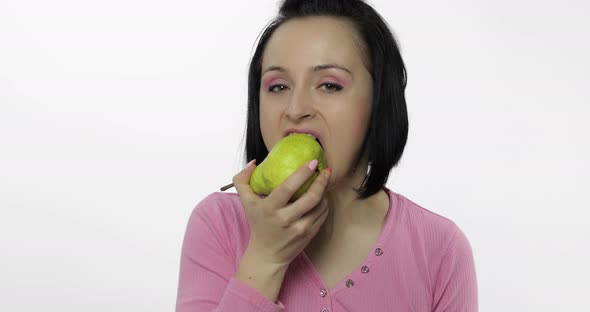 Woman Eating Fresh Pear and Says Yum. Girl Takes First Bite and Say Wanna Bite