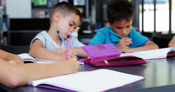 School kids doing homework in classroom
