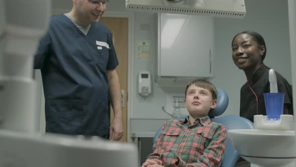 Boy sitting on dentist's chair before treatment