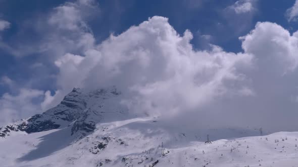 Landscape View of Alpine Mountain Snowy Peak in the Clouds. Simplon Pass