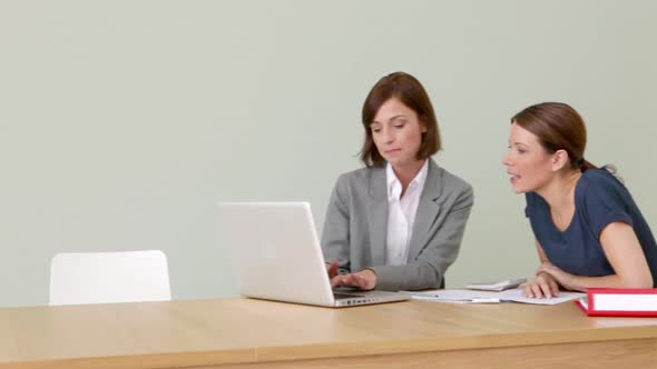 Young woman with financial adviser signing document