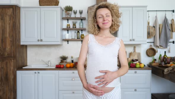 Pregnant Happy Woman Touching Her Belly. Healthy Pregnancy Concept.