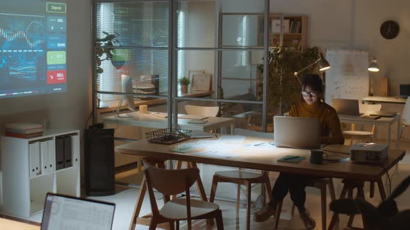 Asian Businesswoman Working in Office during Night