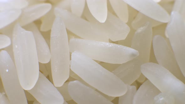 White Polished Long Rice Closeup in Macro Mode Rotates in a Circle