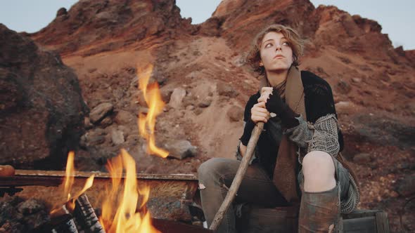 Portrait of Woman by Campfire in Post Apocalyptic World
