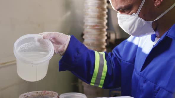 Mixed race man working in factory