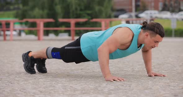 Man Doing Pushups Exercise Outdoors