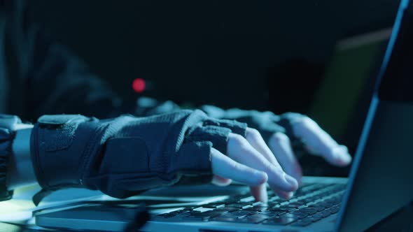 Closeup Shot of Human Hands in Fingerless Gloves Typing