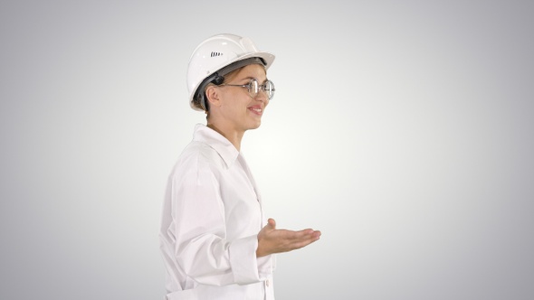 Young Scientist in Lab Coat and Hardhat Walking and Saying