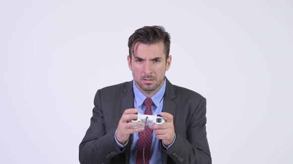 Young Handsome Hispanic Businessman Playing Games