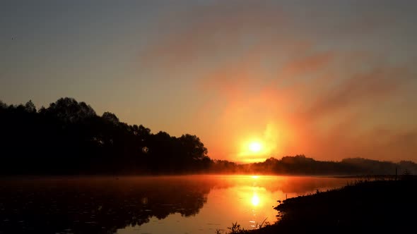 Timelapse of Sunset over the river in a summer evening.