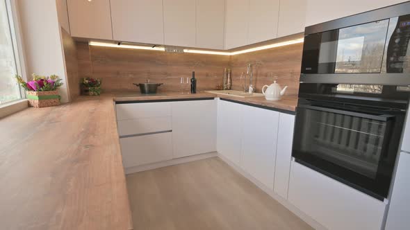 Wide Angle Tilt Shot of Modern White and Wooden Beige Kitchen Interior