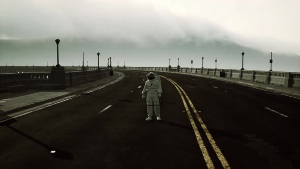 Astronaut Walks in the Middle of a Road