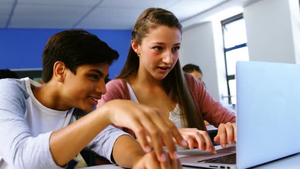 Students using laptop in classroom