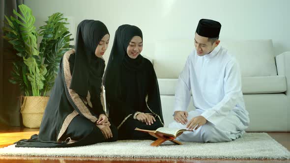 Portrait of Asian Muslim man - women reciting Surah al-Fatiha passage of the Qur'an, in a daily pray