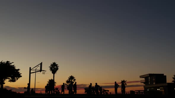 Players on Basketball Court Playing Basket Ball Game Sunset Beach California